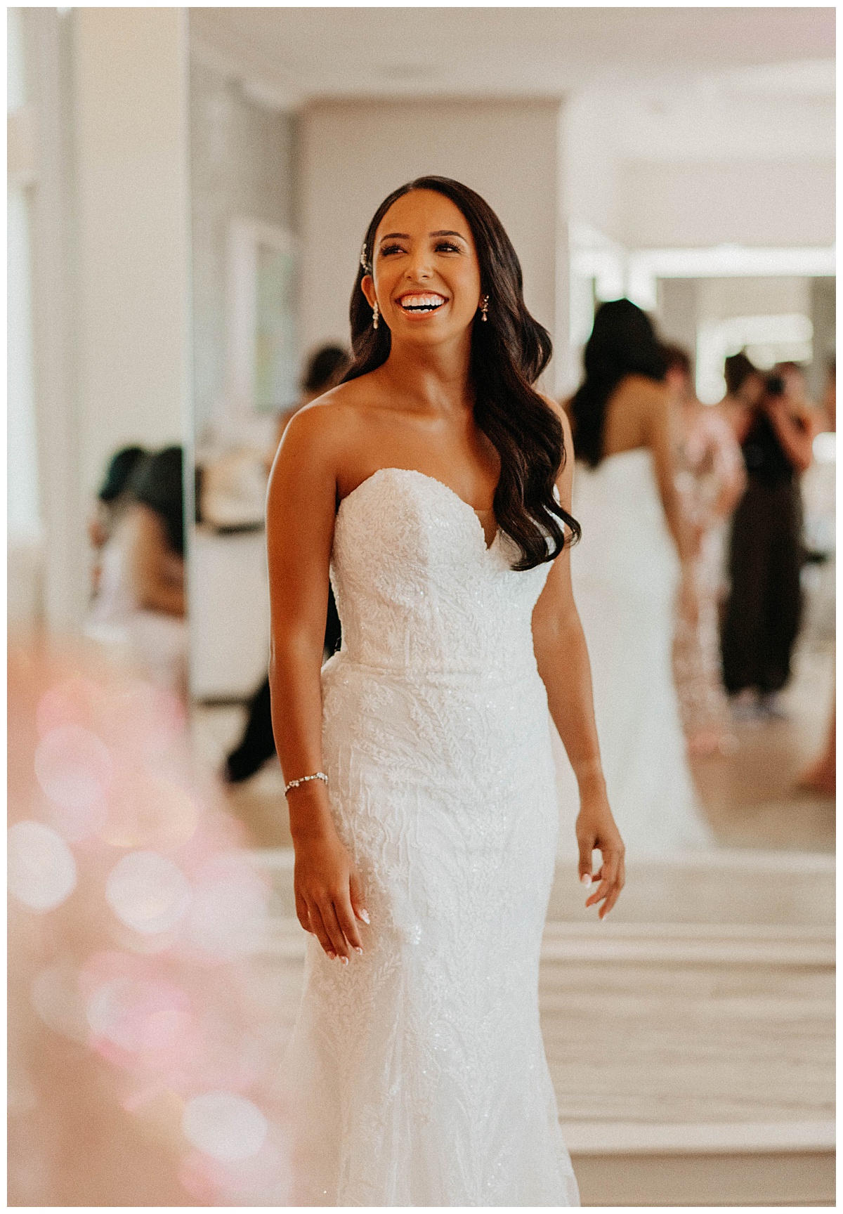 woman grins standing in white lace gown by Texas wedding photographer