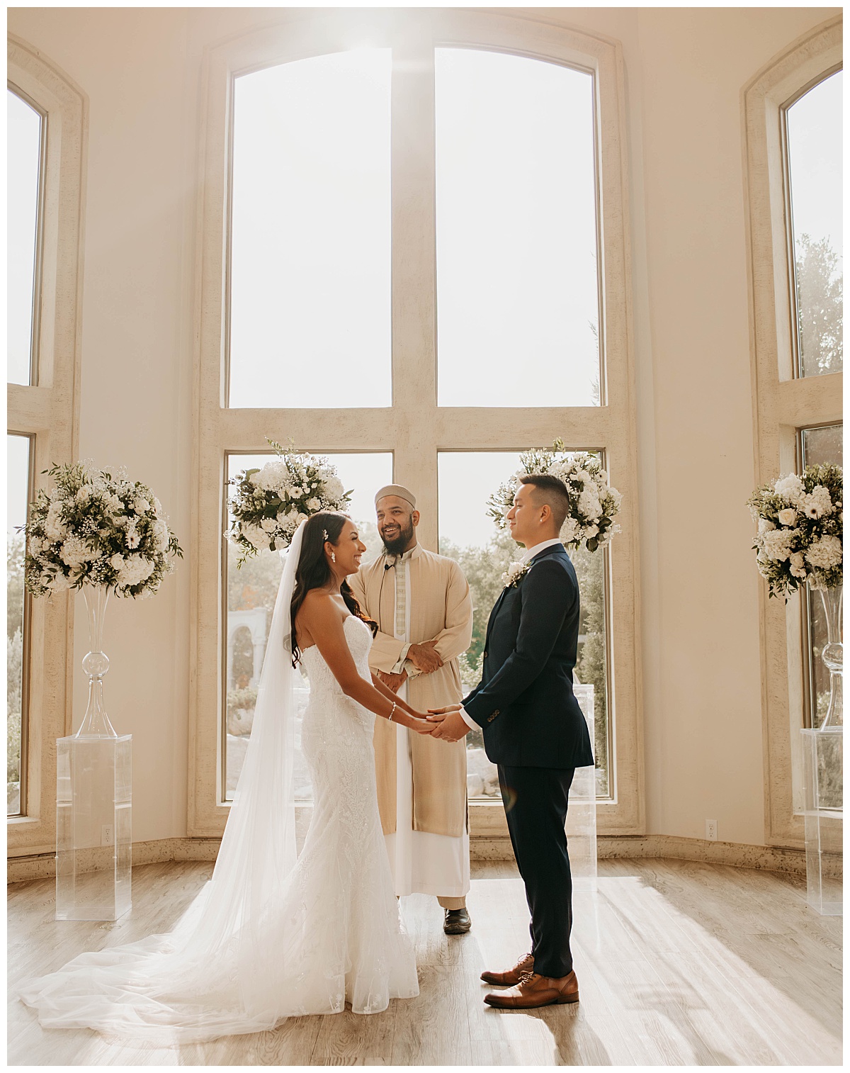 newlyweds hold hands as they exchange vows by Stephanie J. Zamora Photography