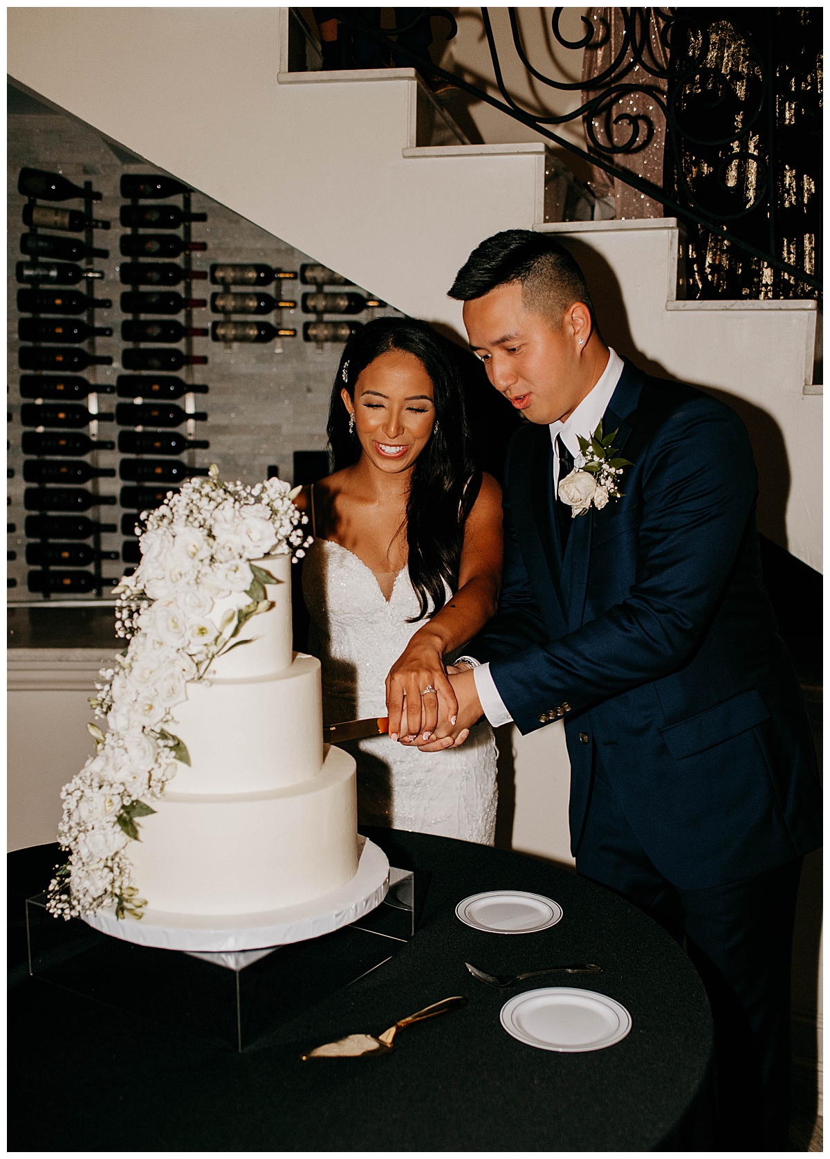 couple cuts wedding cake together by Stephanie J. Zamora Photography