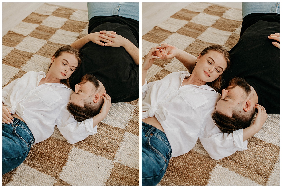 couple lays together on rug while holding hands by Stephanie J Zamora Photography