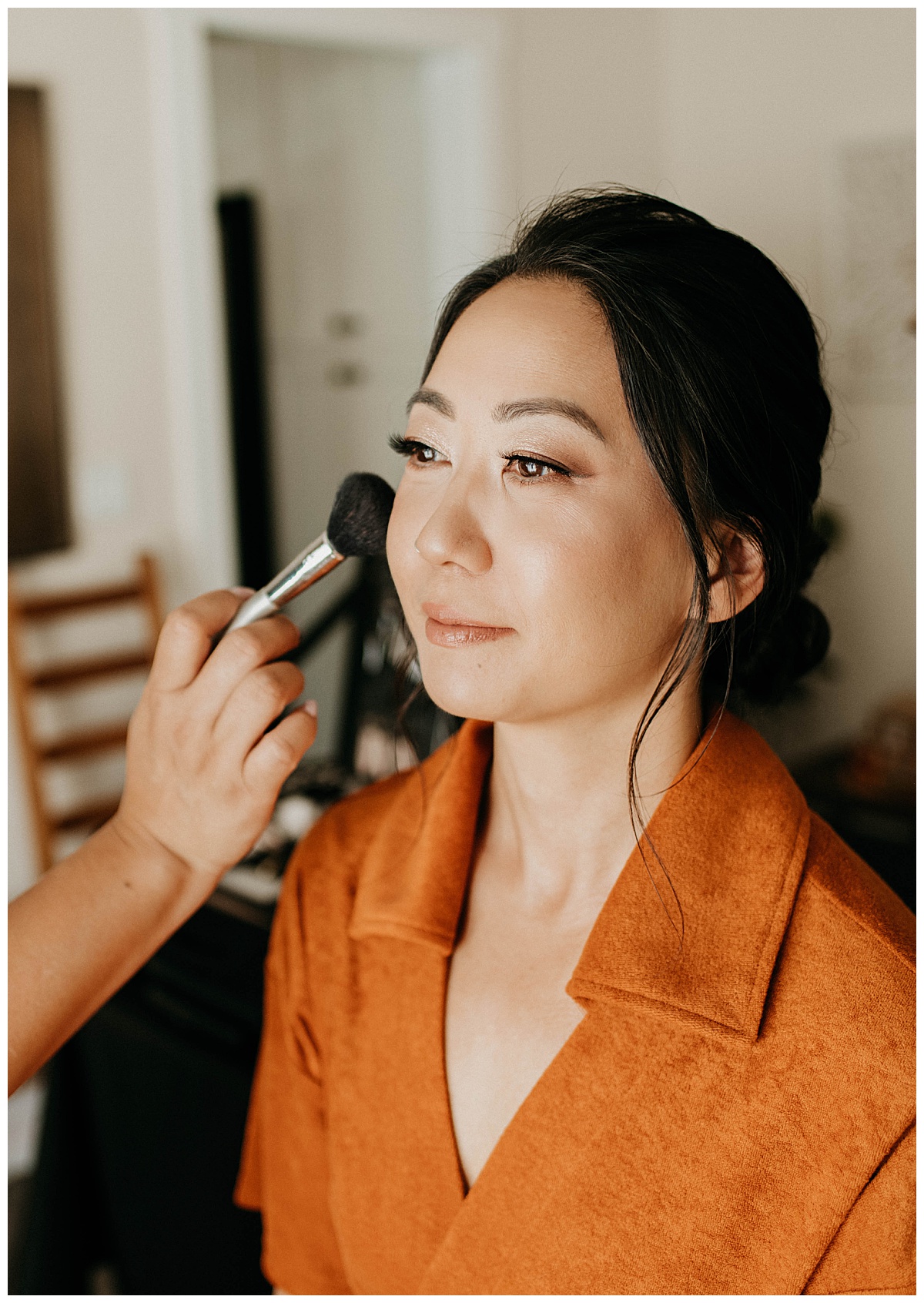 make up is applied to woman's face at Long Beach ceremony 