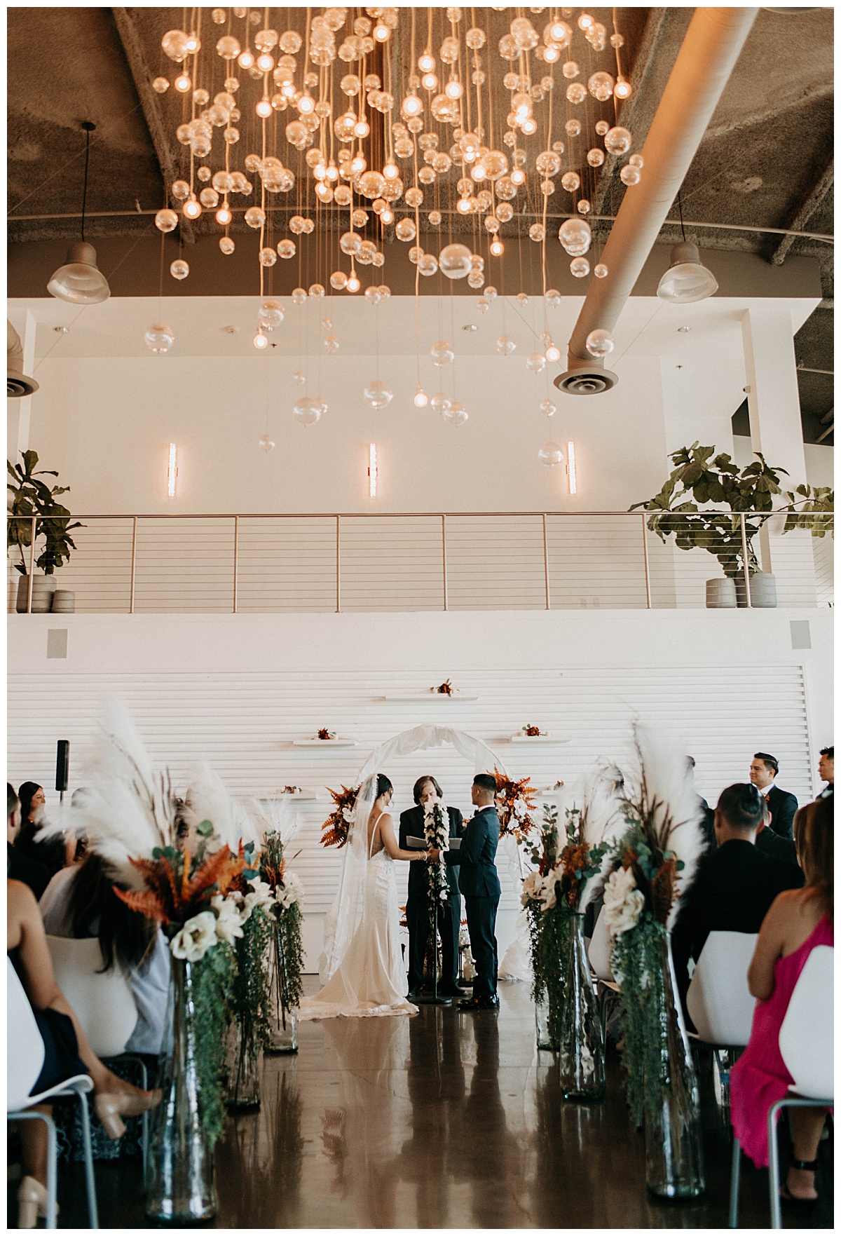 bride and groom stand at altar by Texas wedding photographer