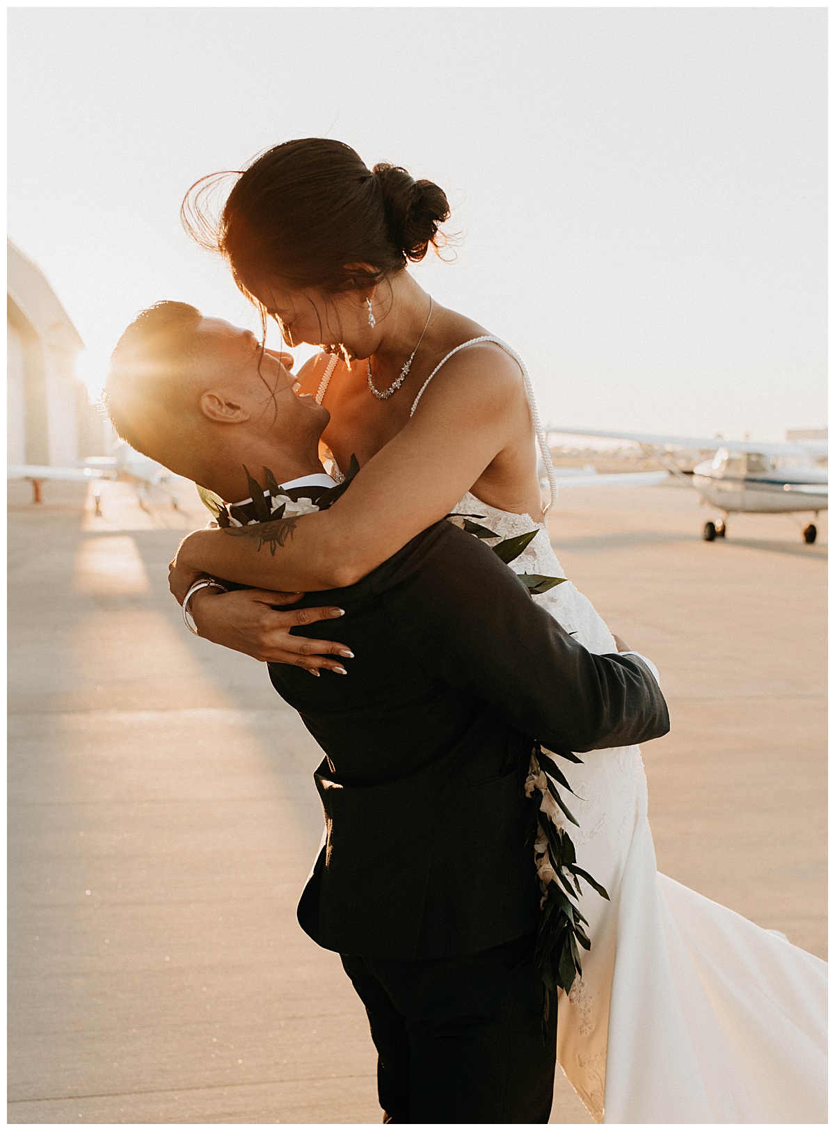 groom picks up bride as they look into each other's eyes by Texas wedding photographer