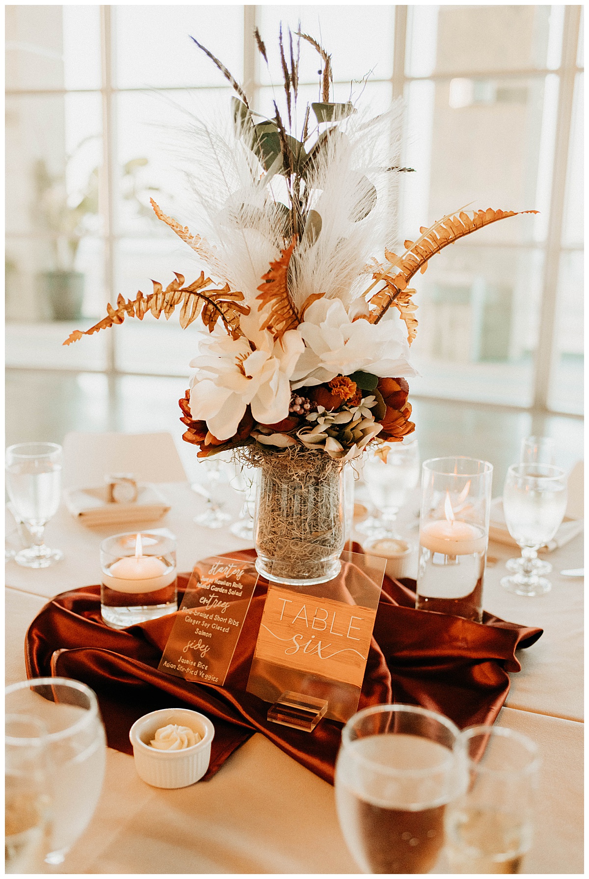 reception table decorated with florals and floating votives by Texas wedding photographer