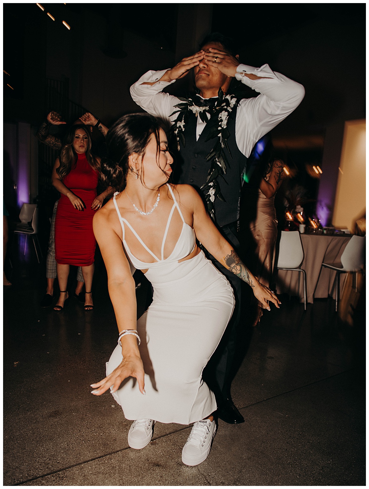 groom covers his eyes as bride dances by Texas wedding photographer