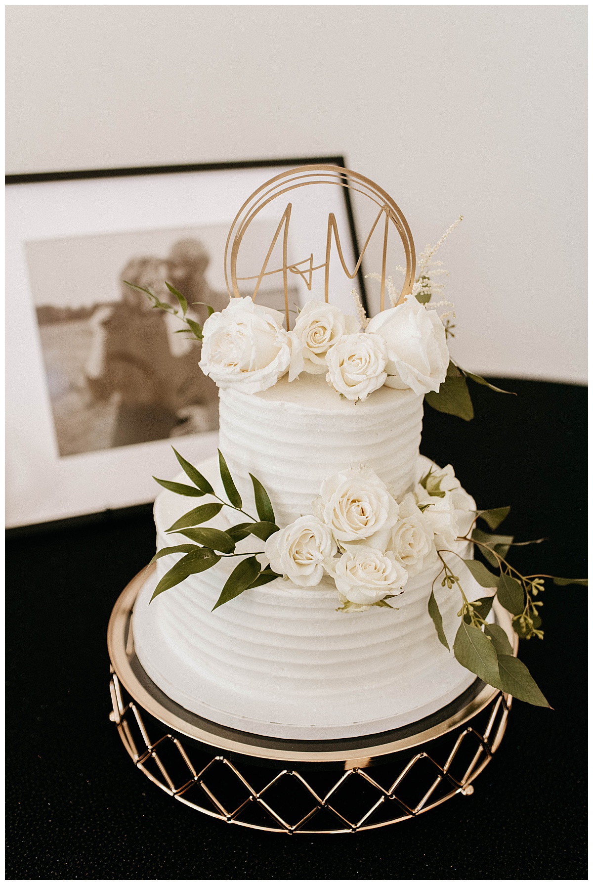 cake decorated with white roses and gold topper by Texas Wedding Photographer