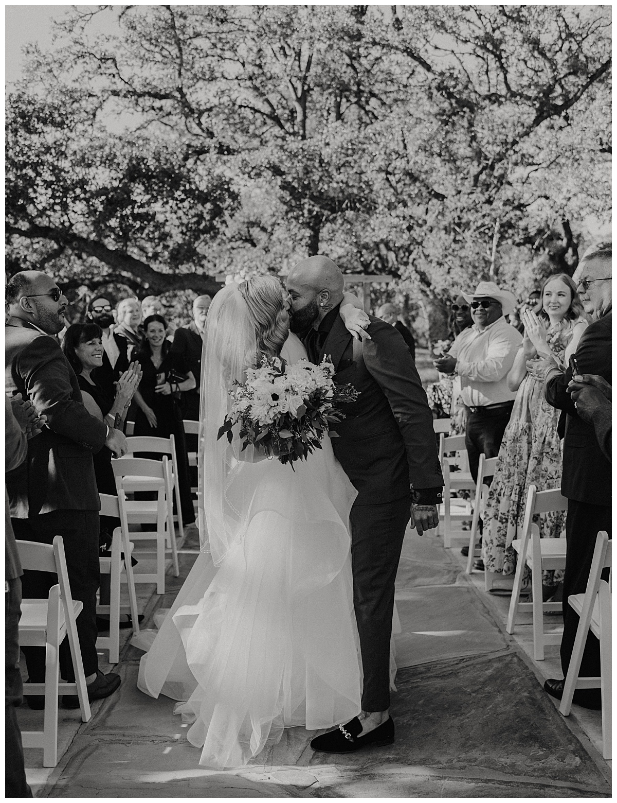 newlyweds kiss after exchanging vows by Stephanie J Zamora Photography