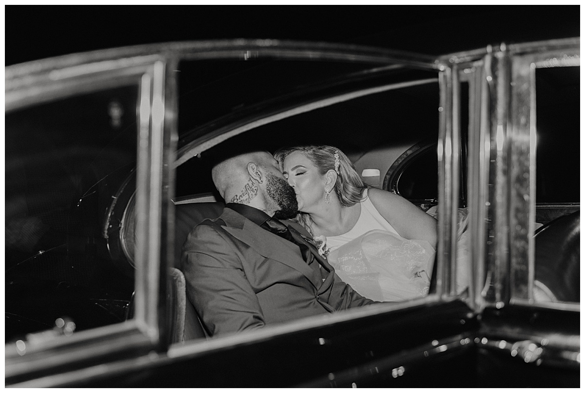 bride and groom kiss in exit car after Posey Meadows ceremony